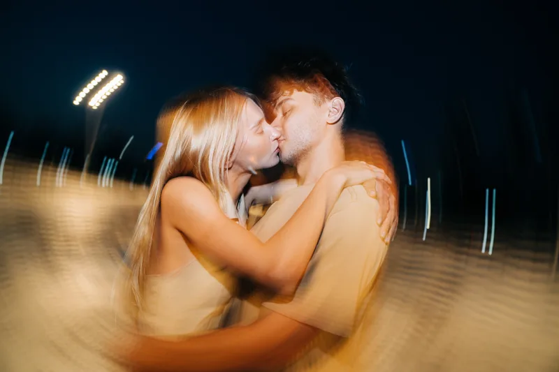 A wedding couple against sparkling city night lights