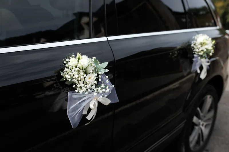 A luxury wedding car outside an elegant venue