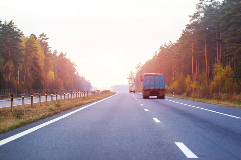 An open highway stretching to the horizon at sunset