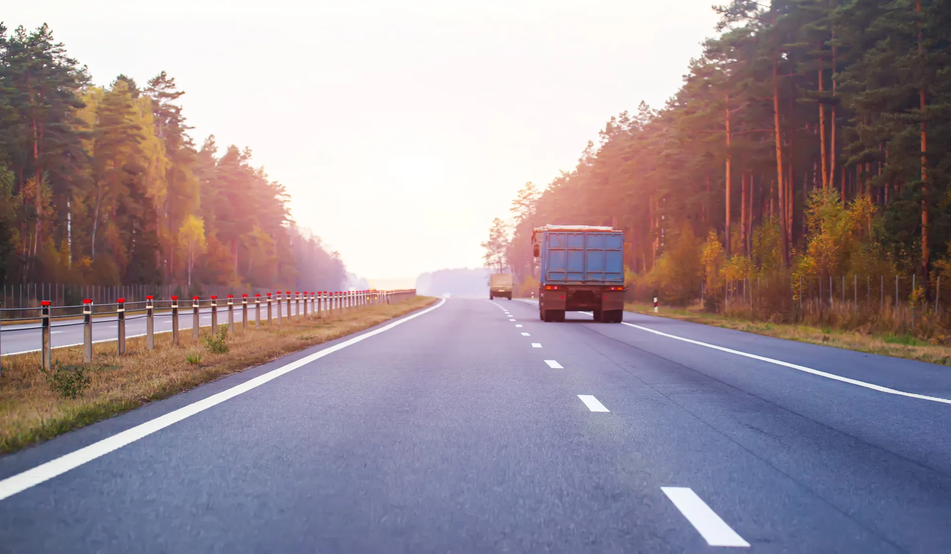 An open highway stretching to the horizon at sunset