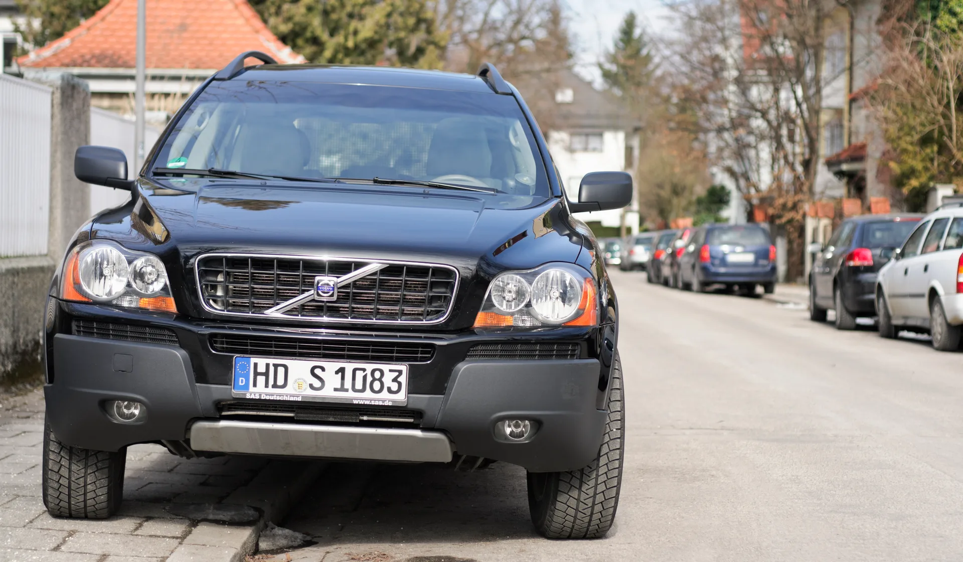 A black premium SUV parked on a residential street