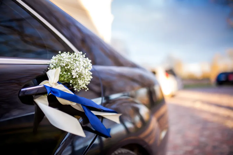A wedding limousine decorated with flowers