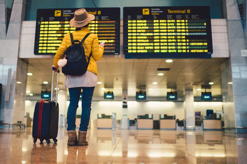 A traveller checking the time at the airport