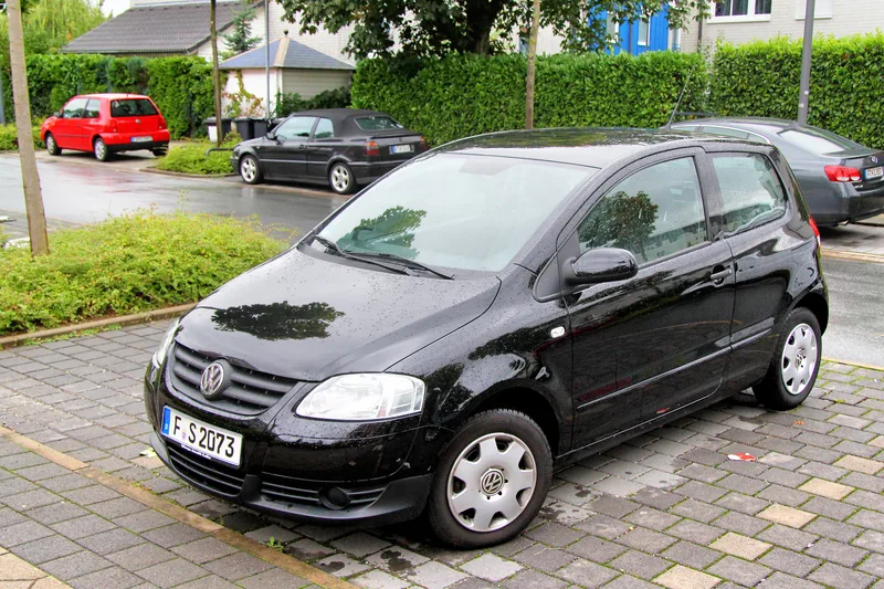 A black SUV on a quiet suburban road