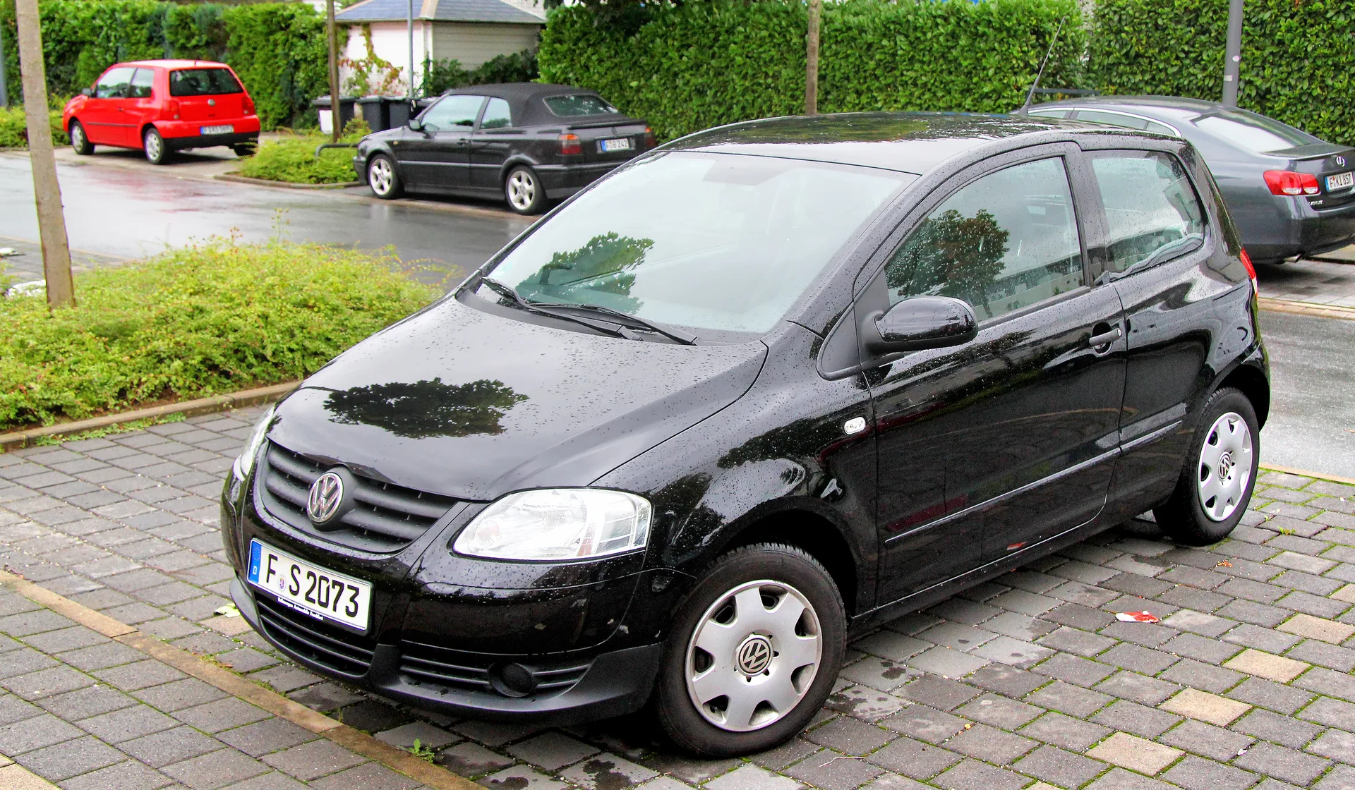 A black SUV on a quiet suburban road