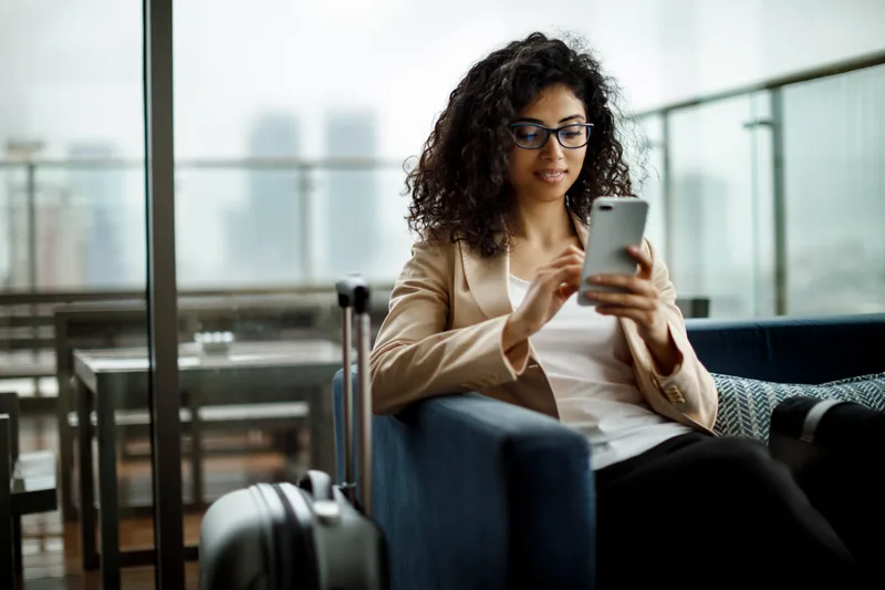 A relaxed traveller at an airport departures lounge
